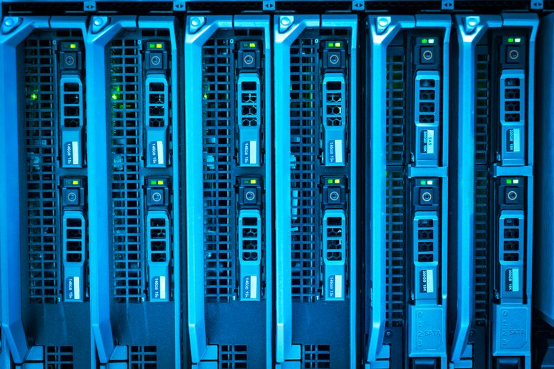 Rows of lit server racks in a data centre.